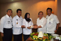 Ketua DPRD Gresik A Hamid memberikan potongan tumpeng Kepada Kepala DPPKAD Gresik, Dr. Yetty Sri Suparyatie. (foto: Humas Pemkab Gresik)